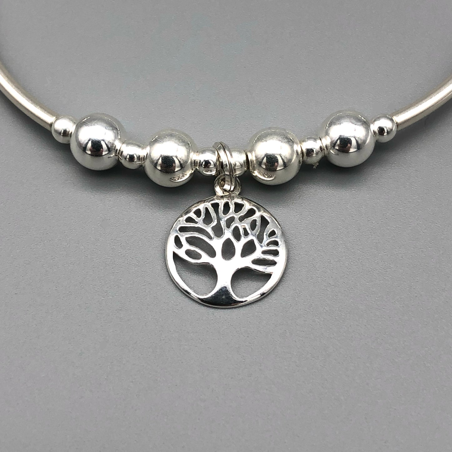 Closeup of Tree of Life charm sterling silver women's hand-made stacking bracelet by My Silver Wish