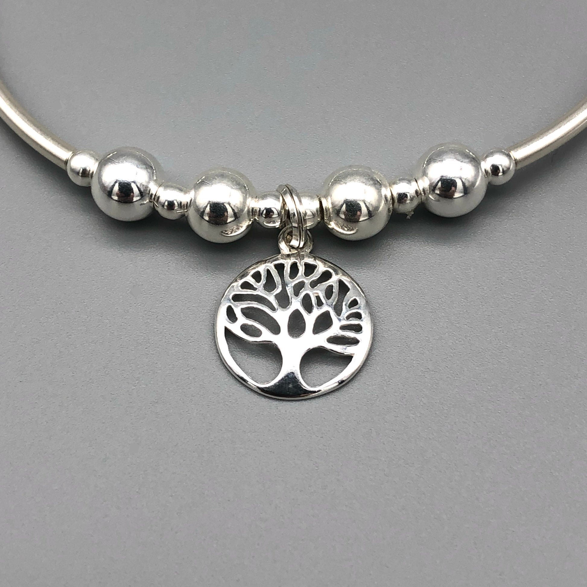 Closeup of Tree of Life charm women's sterling silver stacking bracelet by My Silver Wish