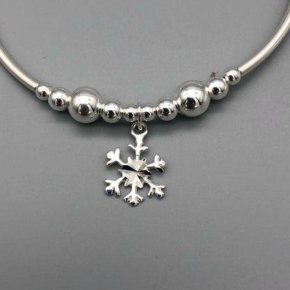 Closeup of Snowflake charm sterling silver stacking bracelet for her by My Silver Wish