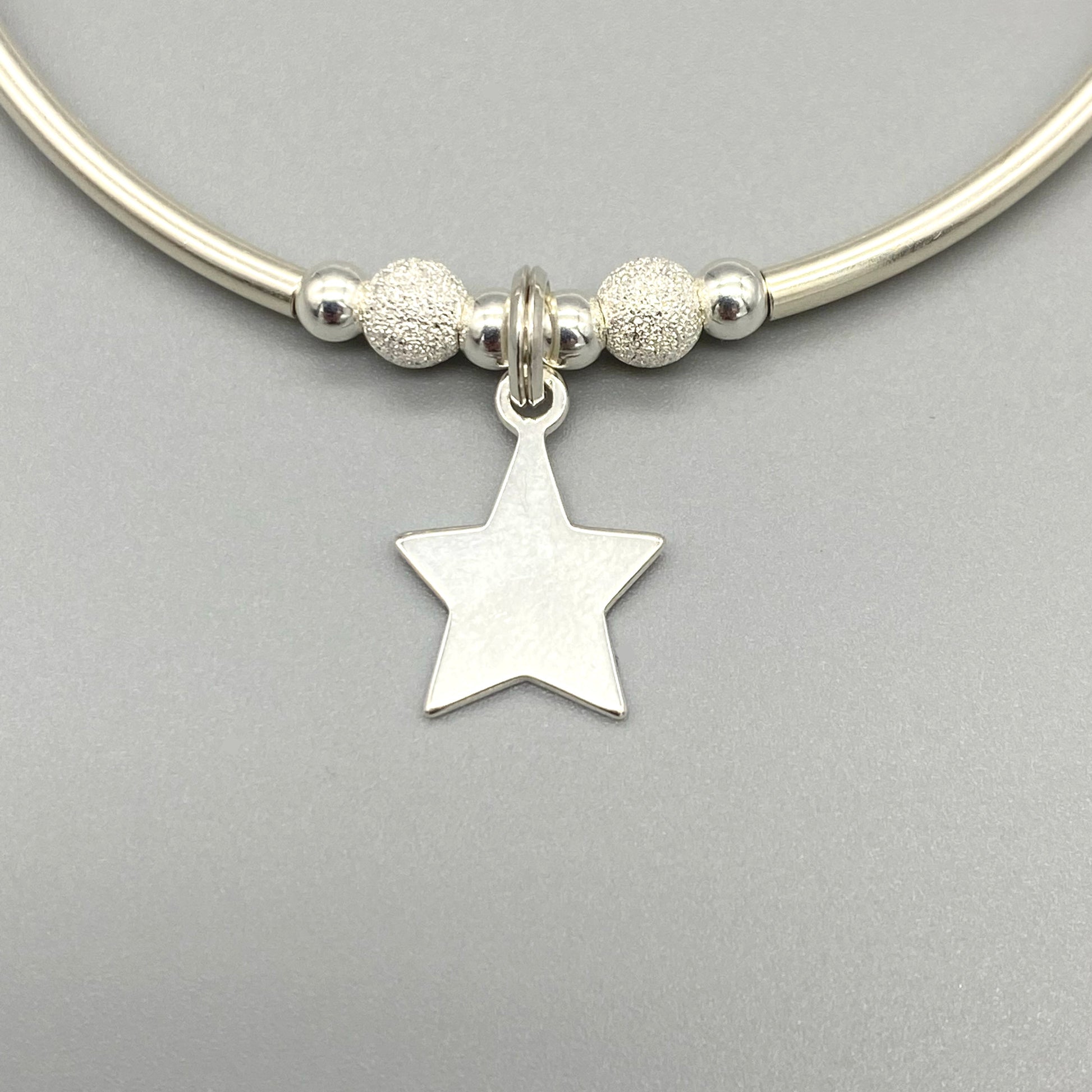 Closeup of Star charm & starburst beads sterling silver stacking bracelet for her by My Silver Wish